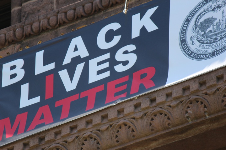 black lives matter banner hanging above the entrance to city hall